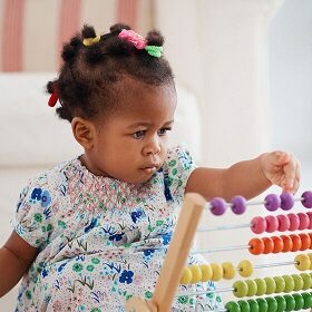 cute african american baby girl playing colorful abacus toy at home école pour surdoué en france