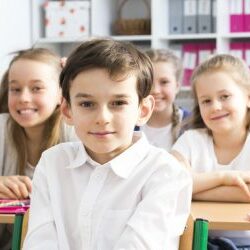 School that makes its pupils smile Panorama of a classroom in primary school with rows of smiling pupils sitting at their desks