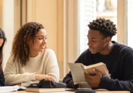 Trois élèves dans une salle de classe d’un lycée privé bilingue à Paris, étudiant ensemble.